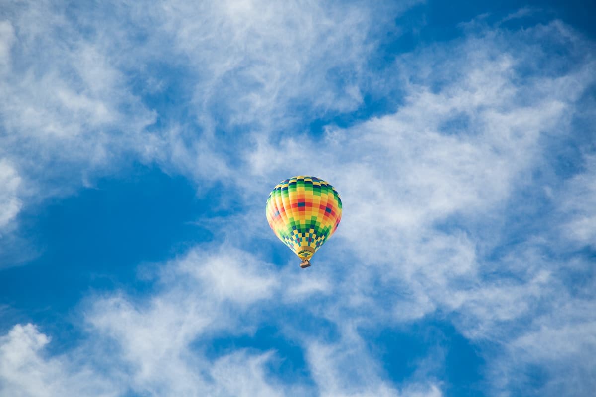 A shot of a hot air balloon floating in the sky. 