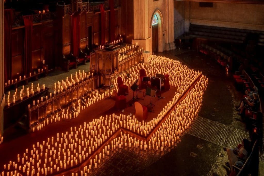 Photo of a candlelit historic concert venue 