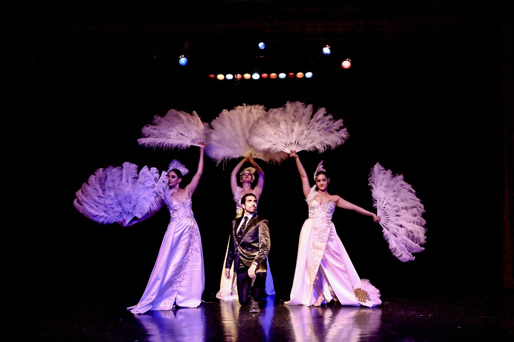 Performers in gorgeous ball gowns perform on-stage at a "BROADWAY in @ The..."experience in Los Angeles.