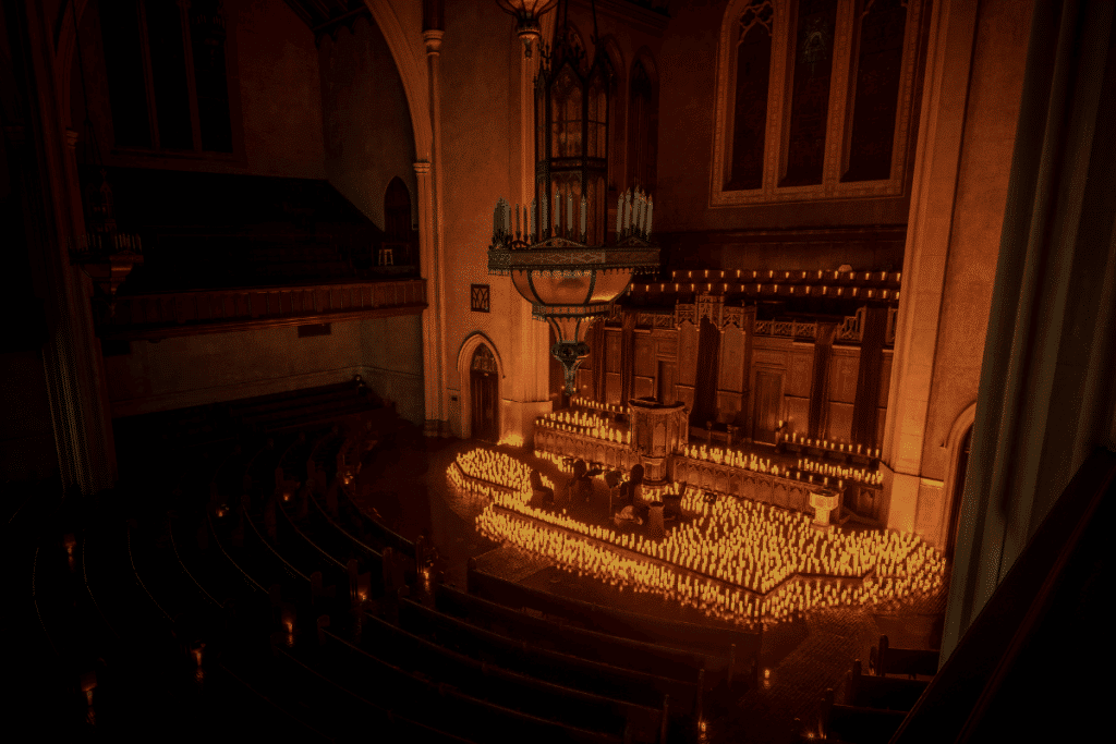 The altar of Immanuel Presbyterian Church covered in candles and a string quartet performing. 