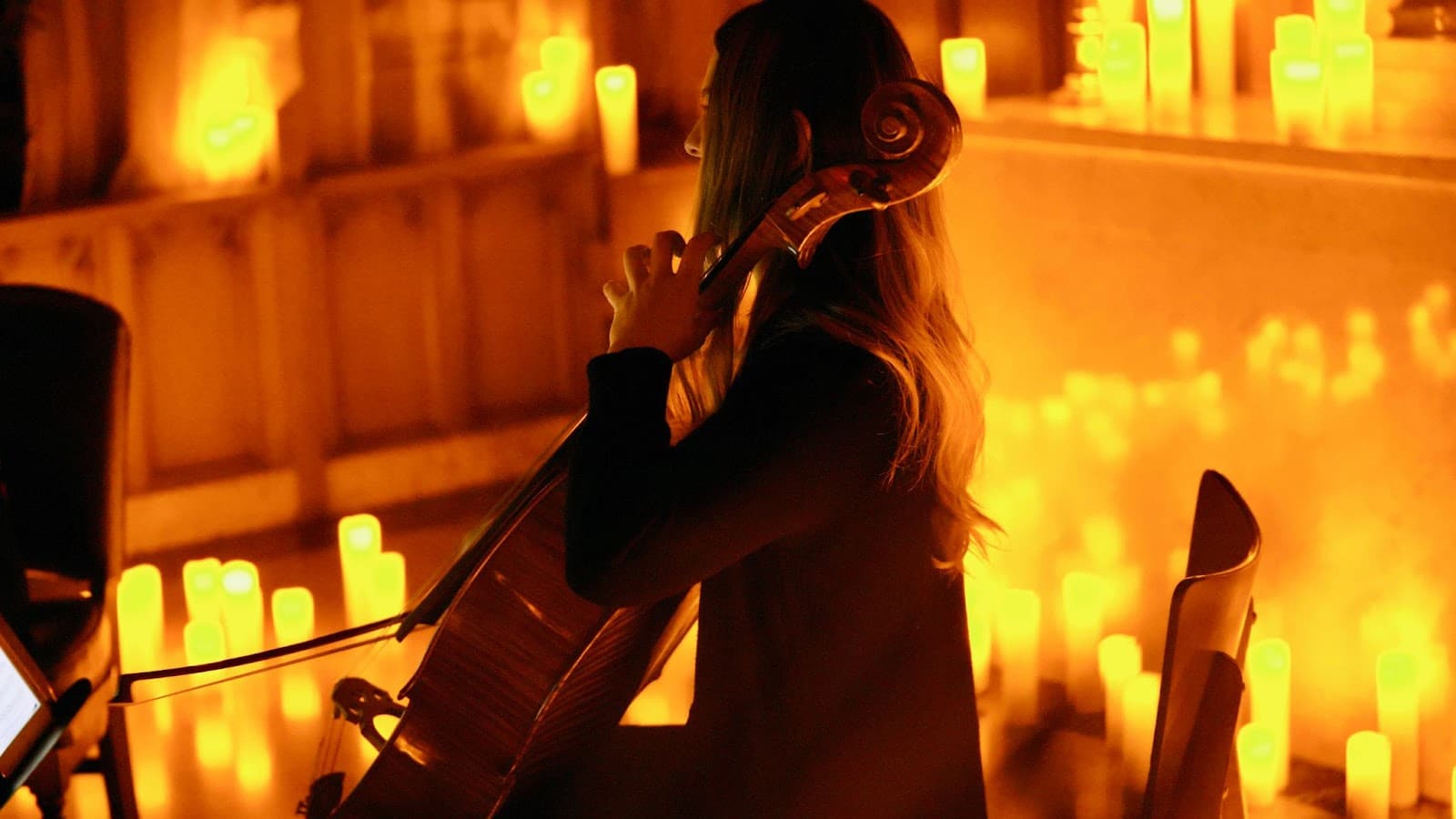 A cellist plays by candlelight