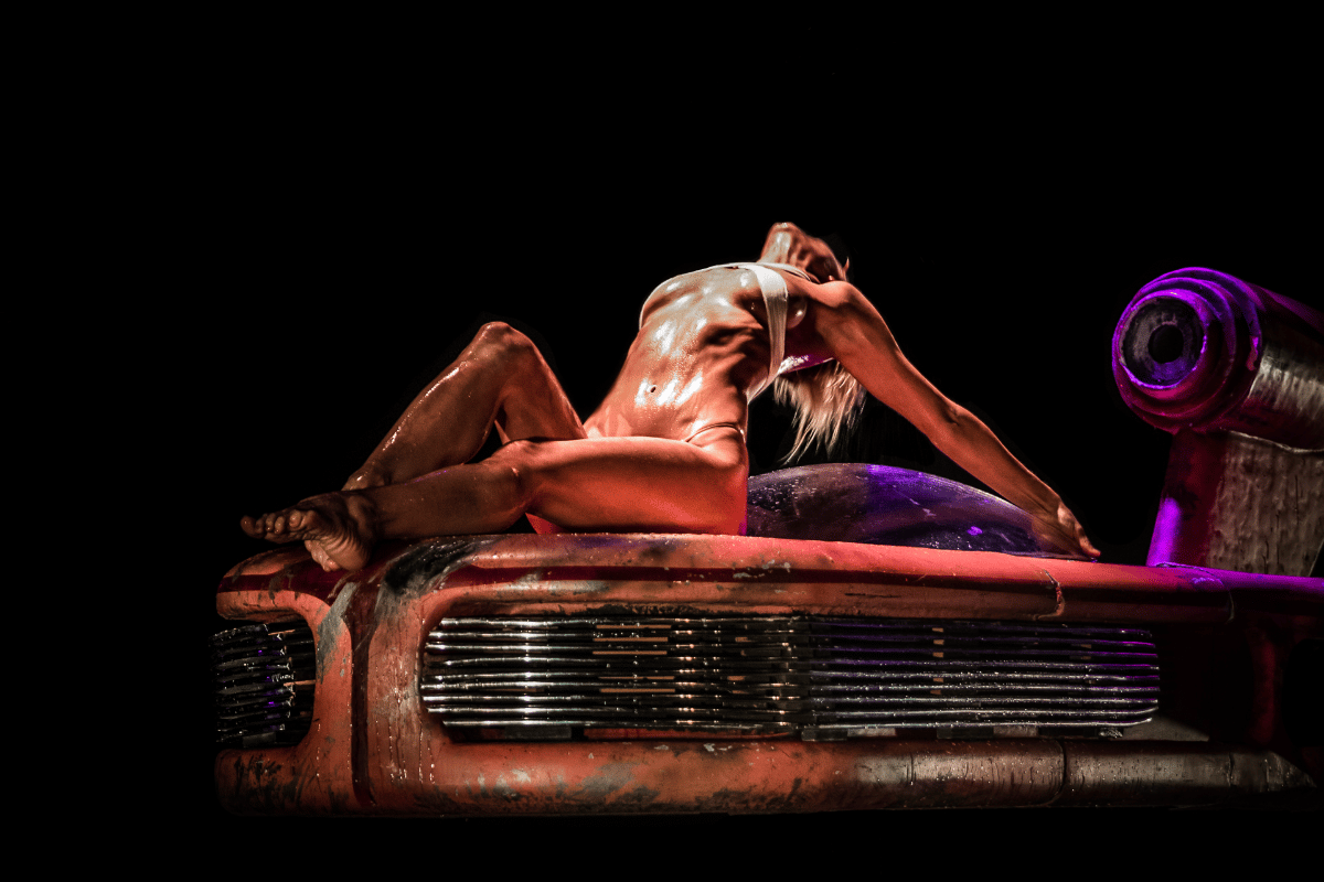 A woman washes a sci-fi speeder in a burlesque dance