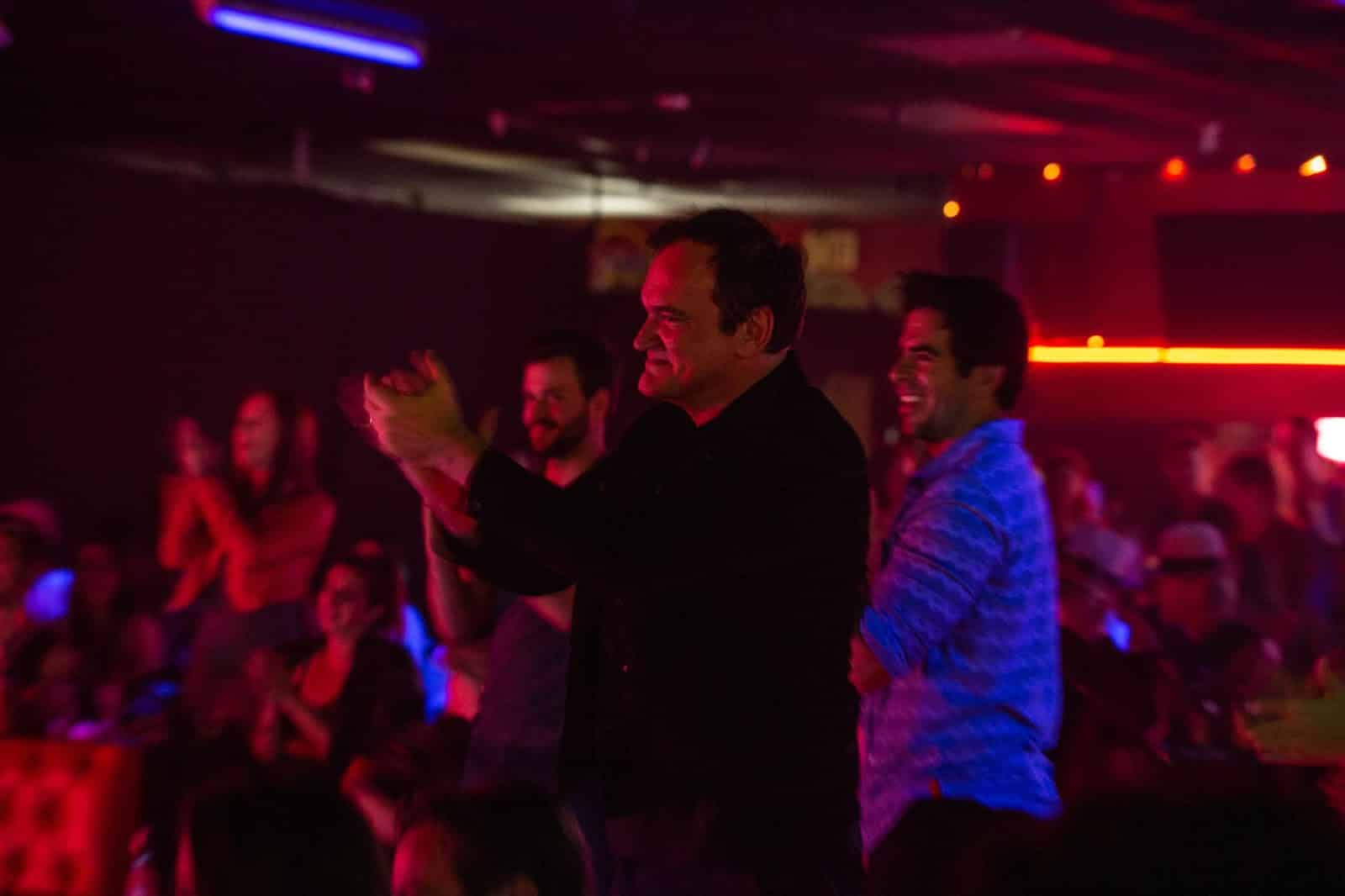 Quentin Tarantino applauds at a show