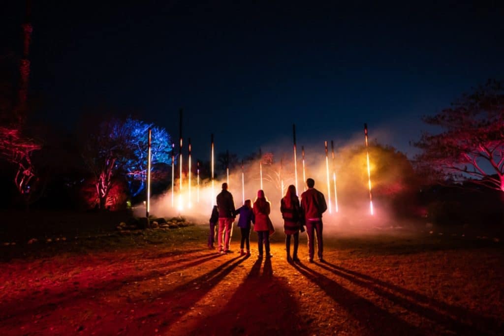A family watches strobing lights at Astra Lumina