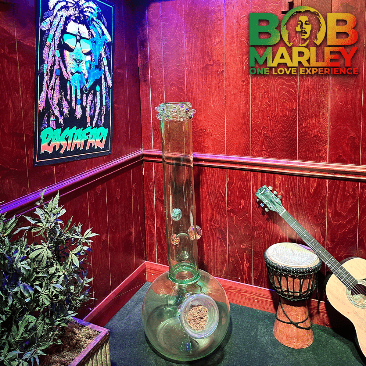 A smoking device sits in a rastafarian room