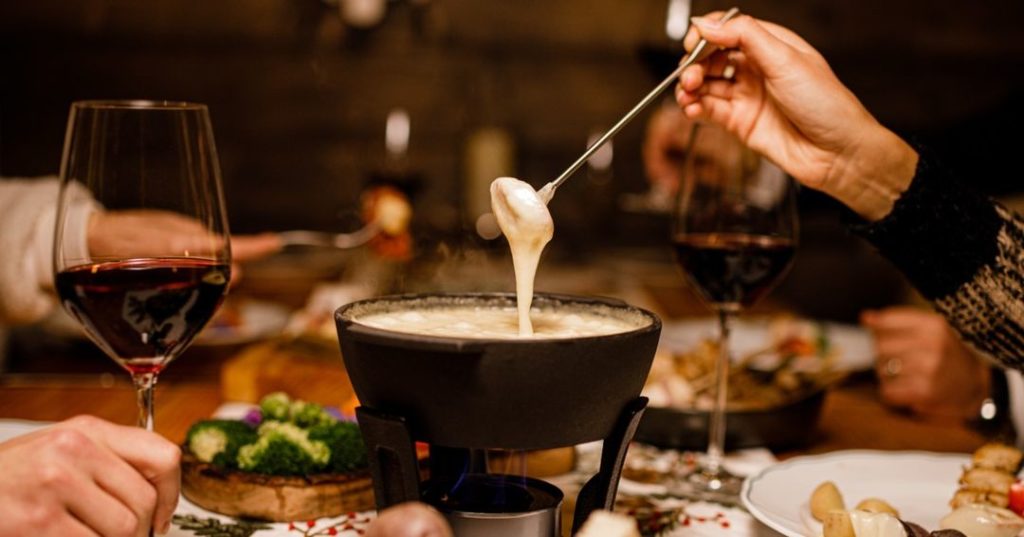 A table with cheese fondue and wine at this apres-ski holiday pop-up at The Century Bar in LA. 