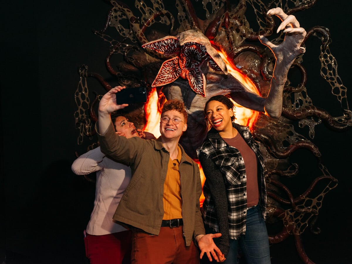 A group poses for a photo with a Demogorgon