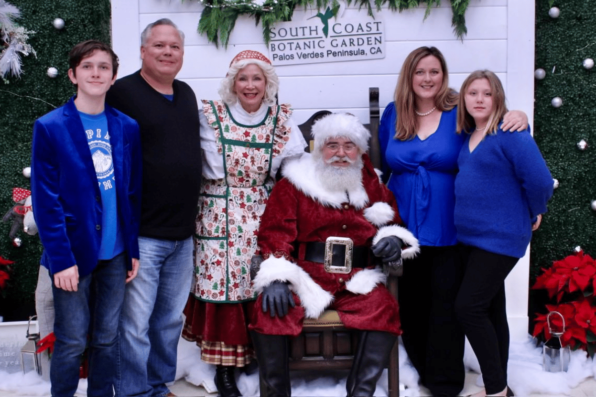 A family takes a picture with Santa