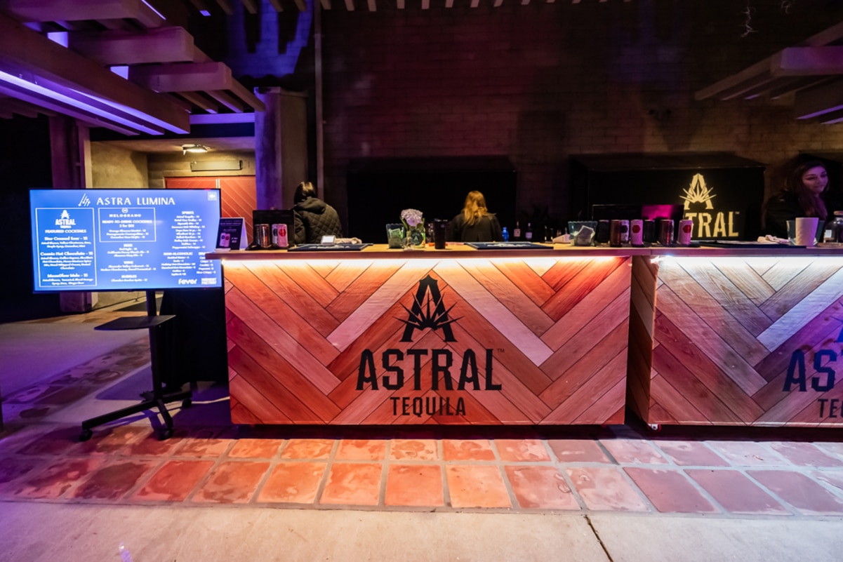 A bar with Astral Tequila's logo painted on the front
