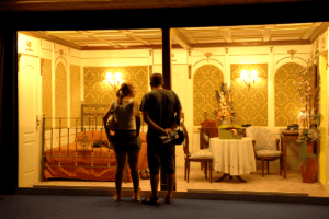 A man and a woman look at recreated rooms of the Titanic