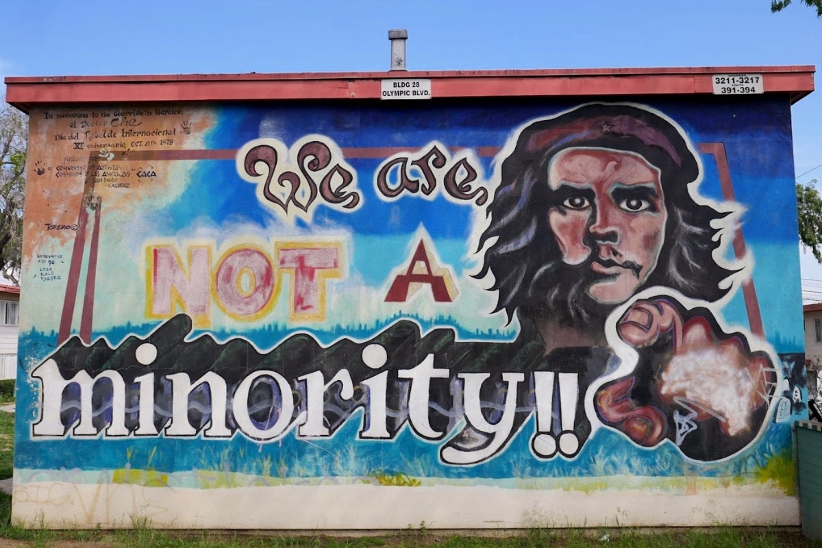 A mural showing Che Guevara pointing at the viewer and a message that reads We are not a minority