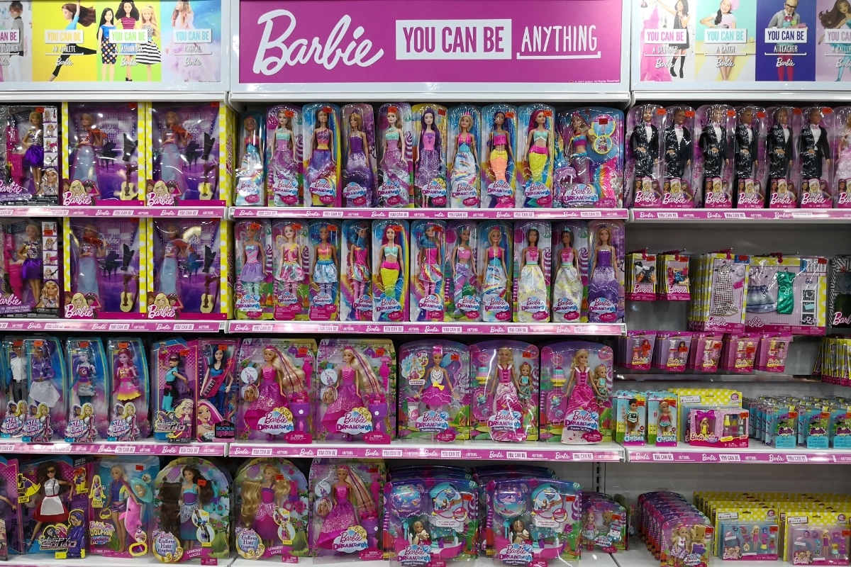 A shelf of Barbie toys