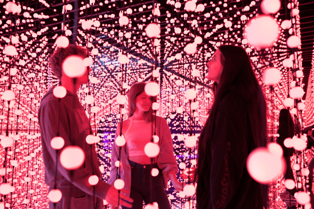 Three people admiring the light display at Bubble World.