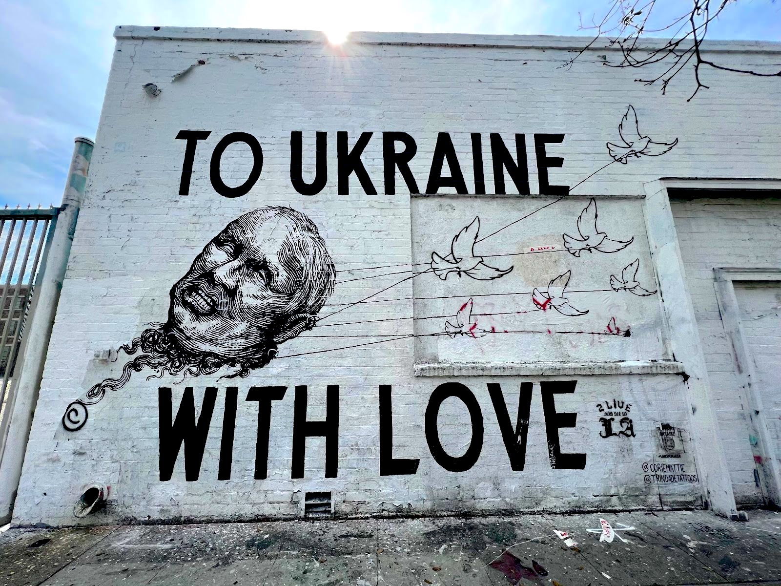 A mural showing Vladimir Putin's head and reading To Ukraine With Love