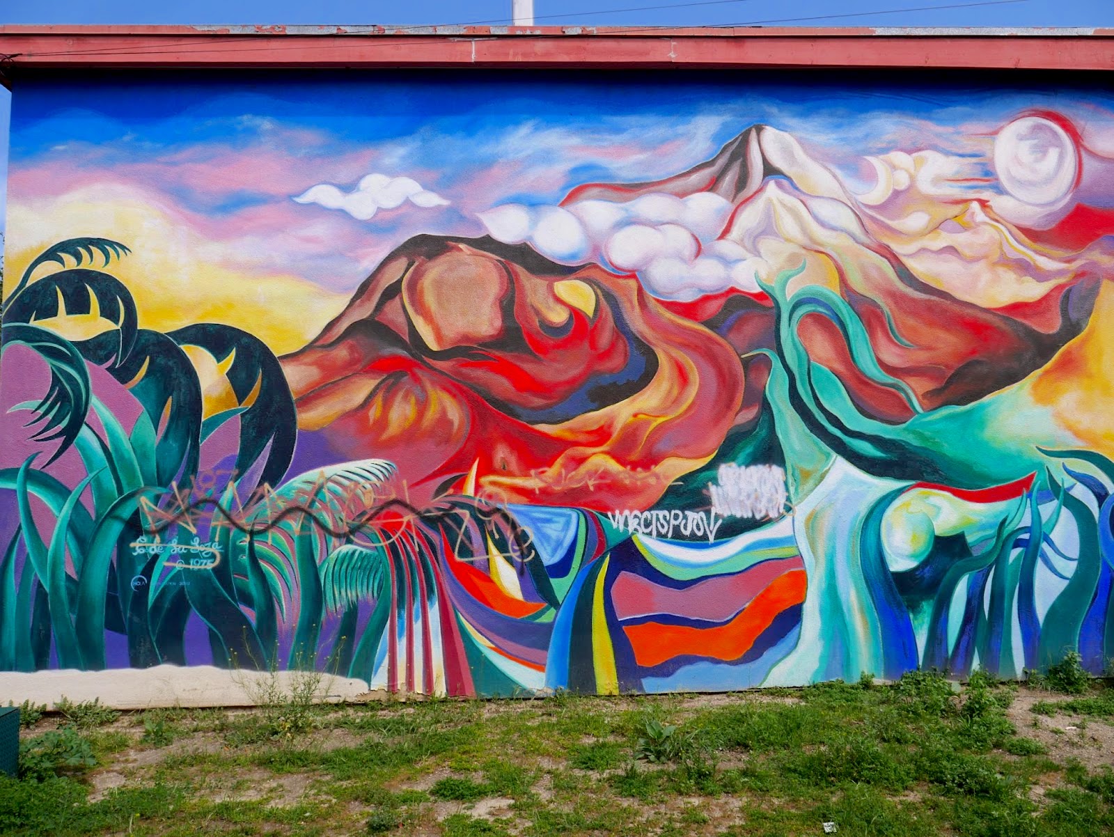 An abstract mural of an island paradise with a colorful mountain in the distance