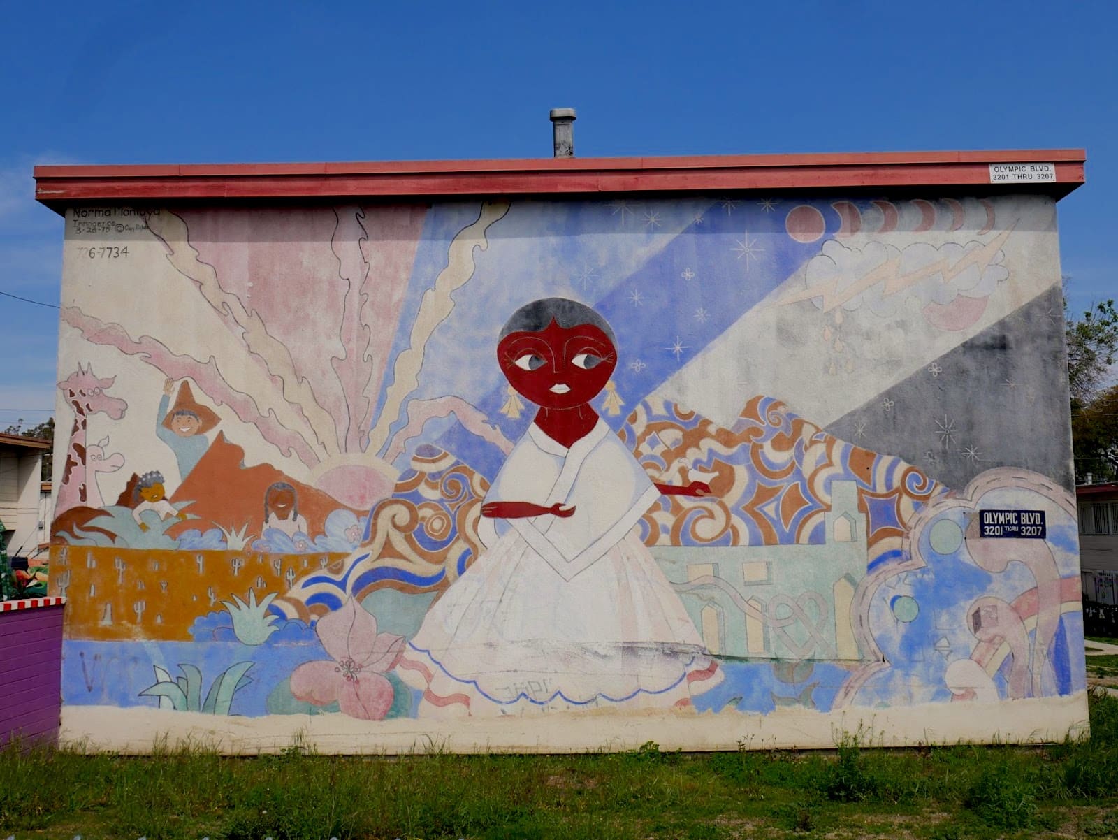 A mural of a young woman standing in front of a psychedelic landscape