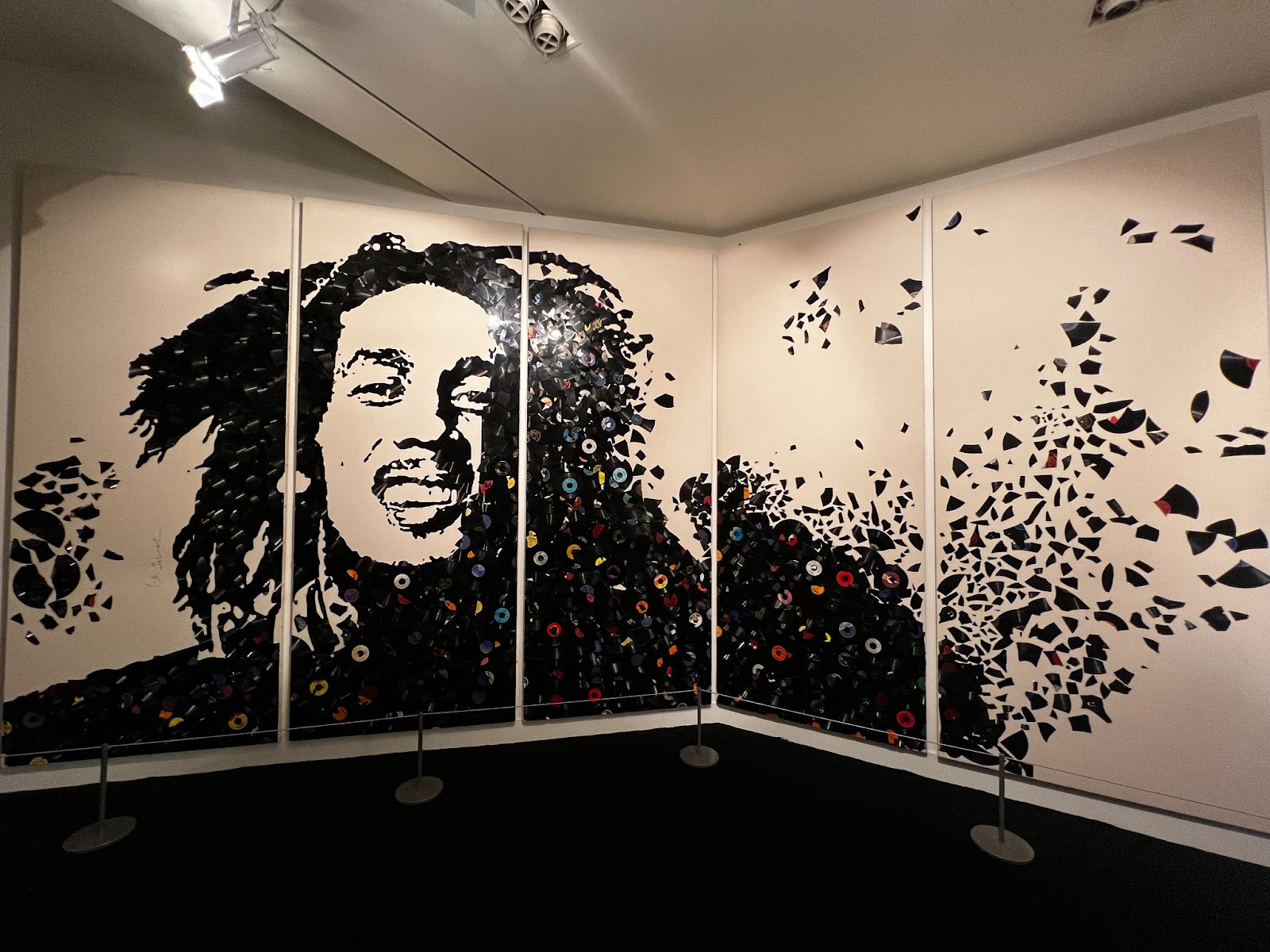 A mural of Bob Marley made out of broken vinyl records