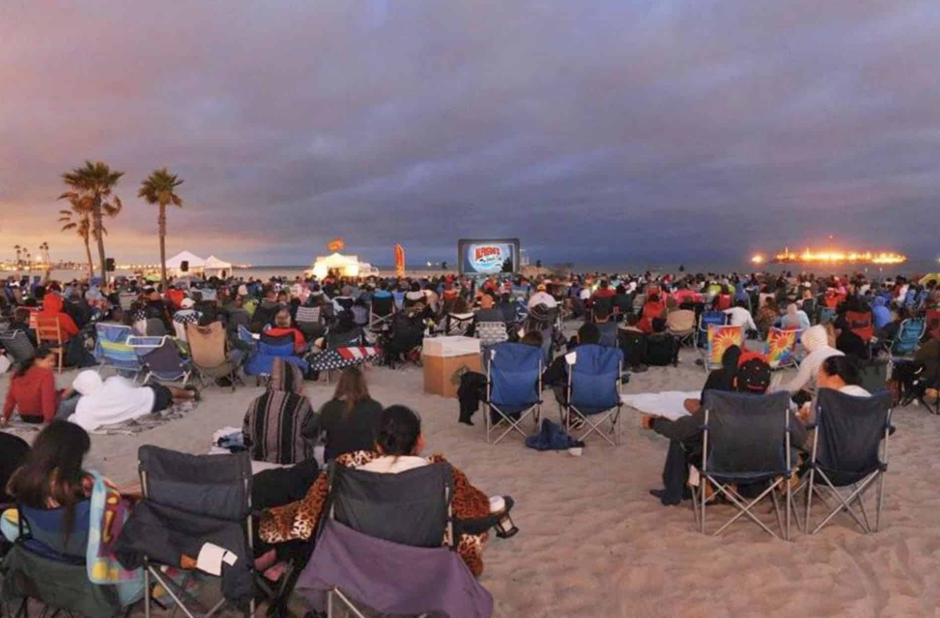 Moviegoers enjoy a film screening on the beach. 
