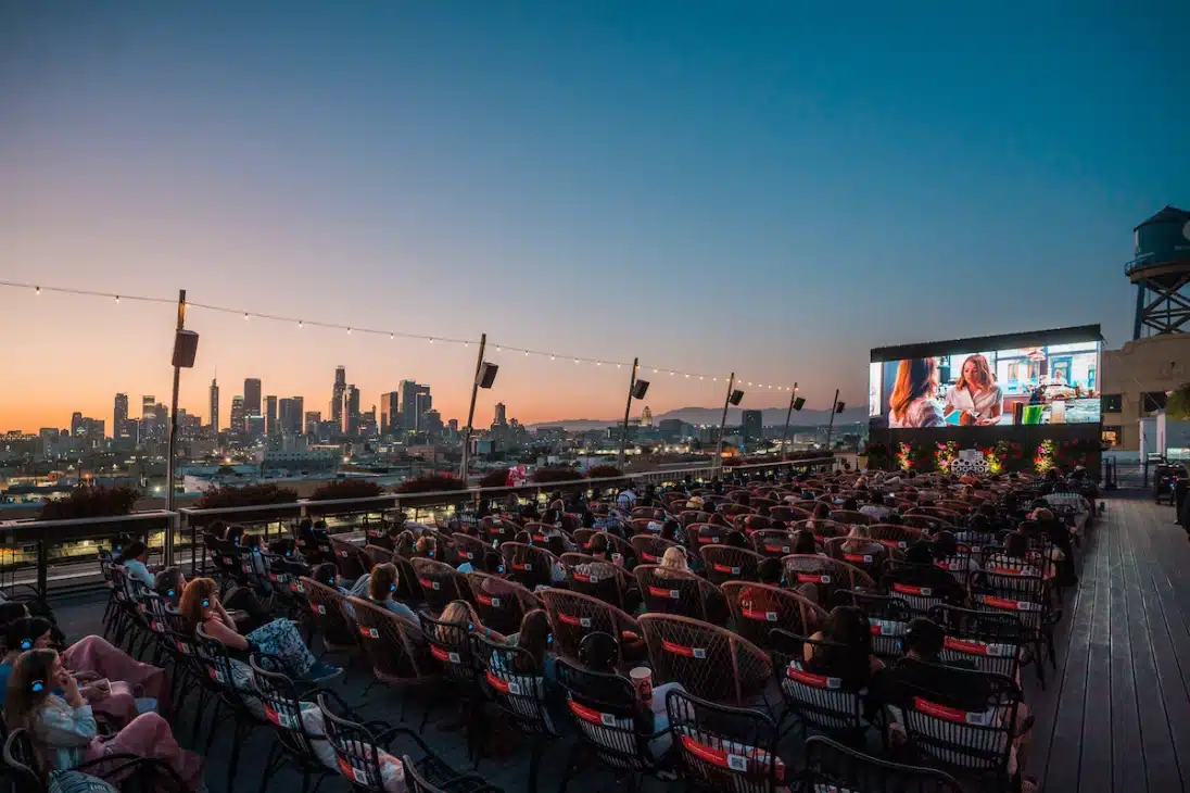A movie screening at dusk with the skyline of Downtown Los Angeles in the background. 