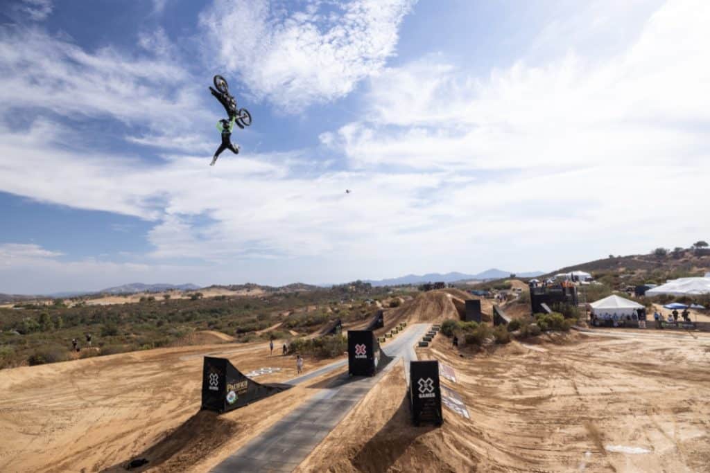 A motocross athlete does a trick in mid-air