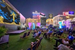 An audience watches a movie on a rooftop
