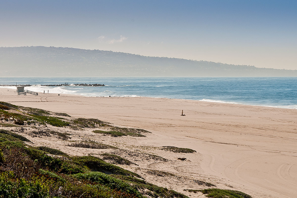 The sandy shore of Dockweiler Beach in Los Angeles.