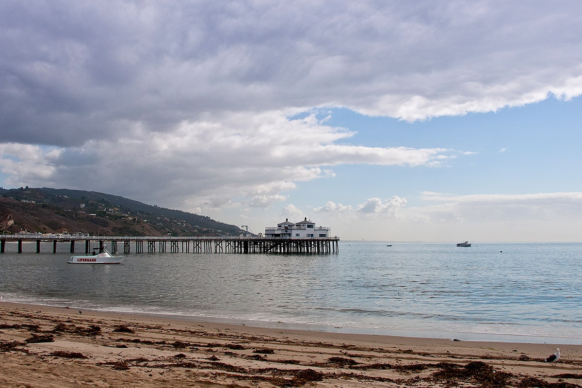 A view of the pier and shore at Surfrider Beach
