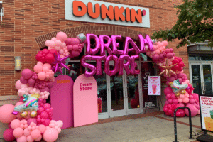 Exterior of Dunkin’ Donuts Dream Store covered in pink balloons