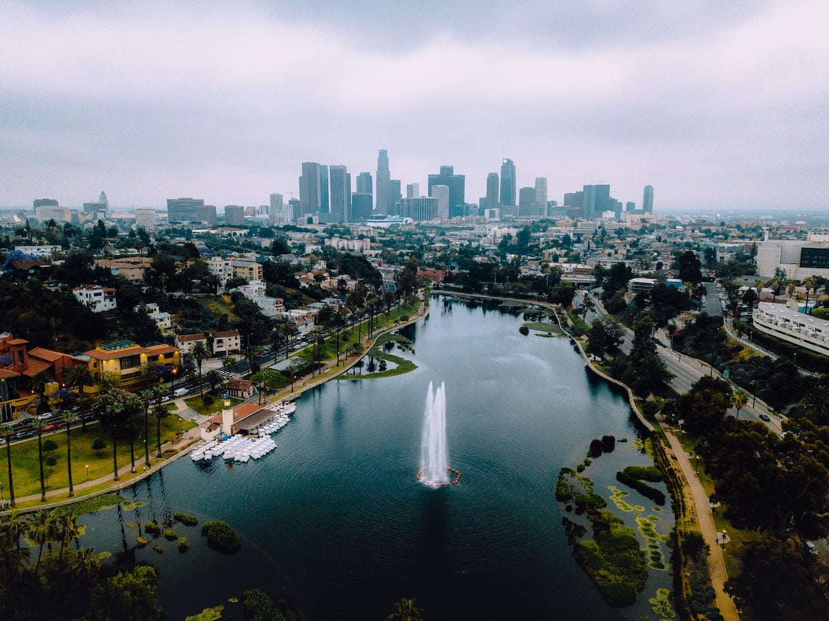 An aerial shot of the lake at Echo Park with the Downtown Los Angeles skyline in the background.