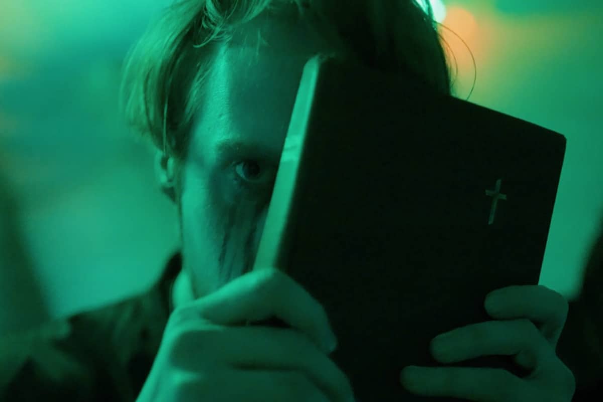 A priest hides behind the bible