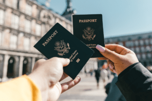 two people holding up their U.S. passports