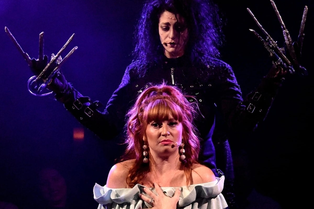 Actors dressed as characters from Edward Scissorhands perform onstage