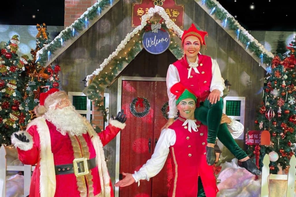 Santa's Circus performers pose onstage with Santa