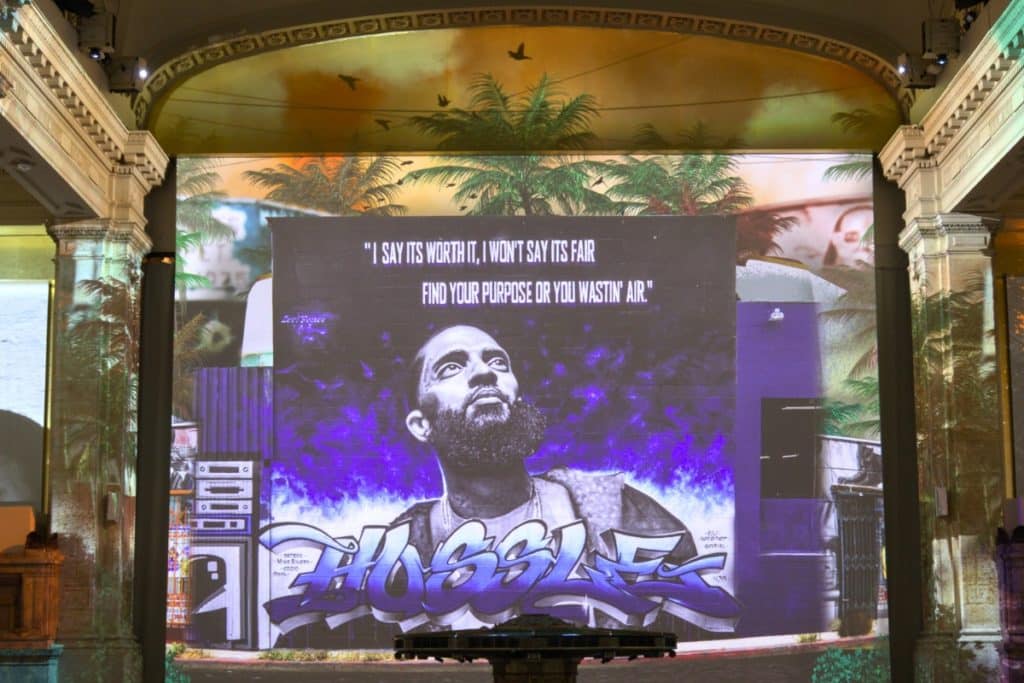 A large portrait of Nipsey Hussle